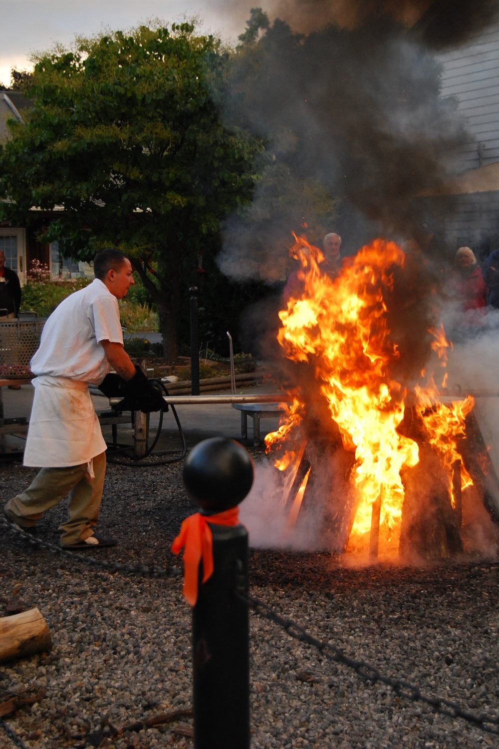 A traditional Door County fish boil with flames rising from the kettle